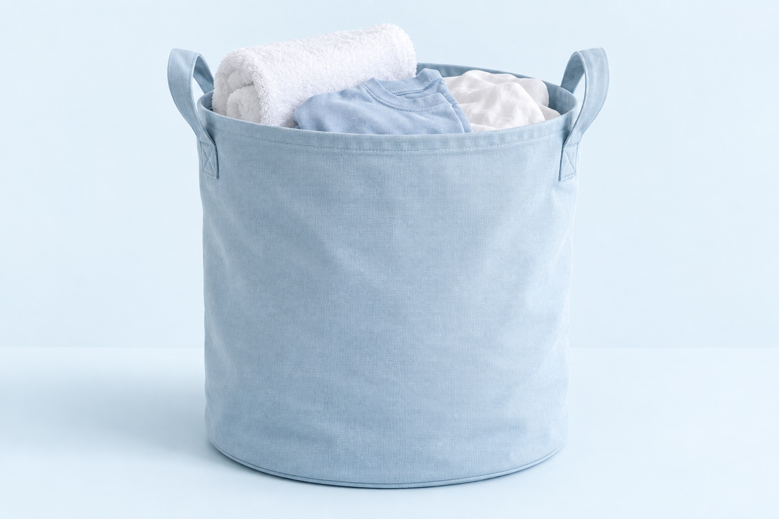 Blue laundry bag filled with clothes and towels
